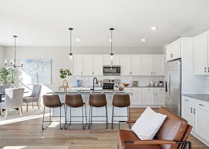 A modern kitchen with white cabinets and a central island.