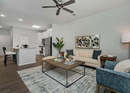 A living room with a blue chair and a coffee table.