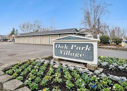 A sign that says Oak Park Village is in front of a building.