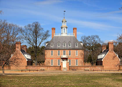 A large brick building with a white cupola on top.