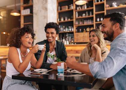 Four people are sitting around a table in a restaurant at Triton Glen, Glen Allen, Virginia