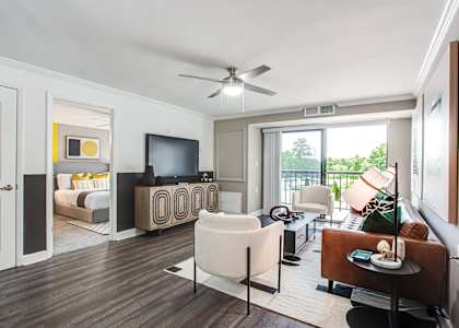 A living room with a television, a chair, and a table.