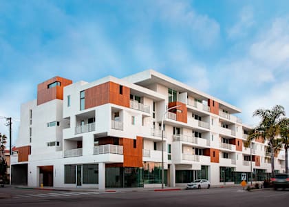 a modern apartment building on a street with cars at The Lucky Apartments, Culver City, CA, 90066