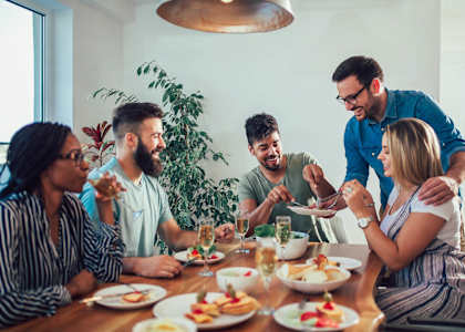a group of people sitting around a table eating food