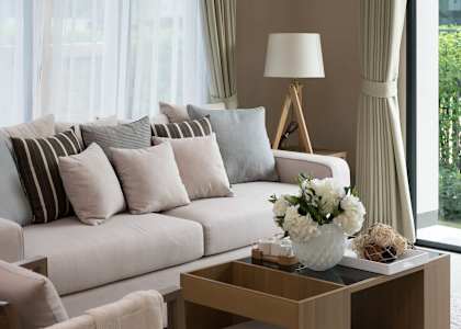 a living room with a white couch and a coffee table