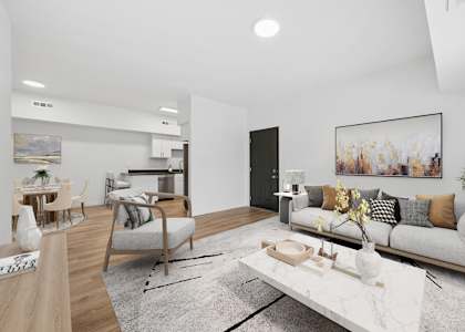 A modern living room with a white sofa, a coffee table, and a dining table with chairs.