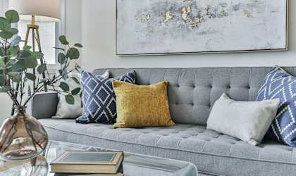 a living room with a gray couch and pillows