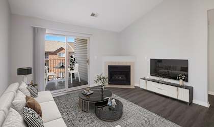 a living room with a fireplace and sliding glass doors to a patio