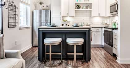 a kitchen with a center island with two stools at Edge 35, Indianapolis, Indiana