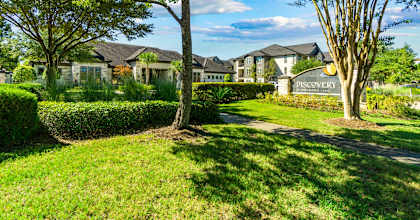 a park with trees and a sign in front of houses at Discovery at Kingwood, Kingwood, 77339