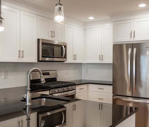 a kitchen with white cabinets and stainless steel appliances at Zephyr Ridge Apartment Homes, Cedar Grove, New Jersey, 07009