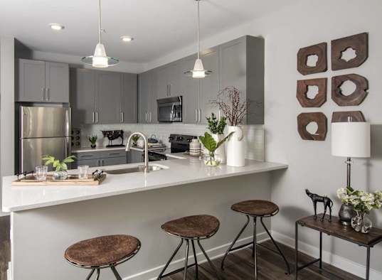 a kitchen with a counter and stools