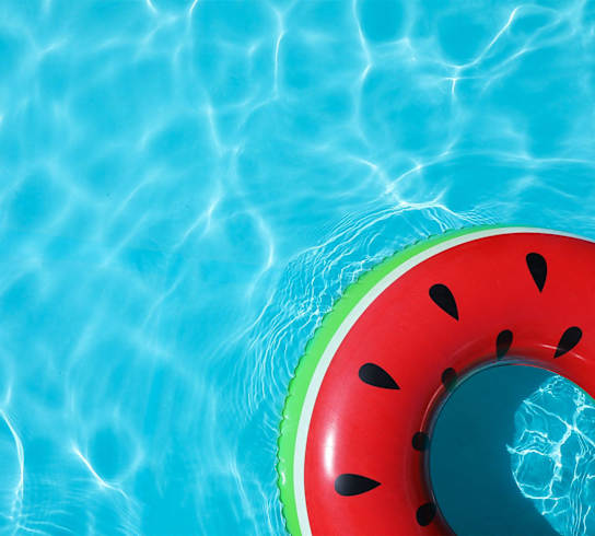 A watermelon-shaped float in a pool.