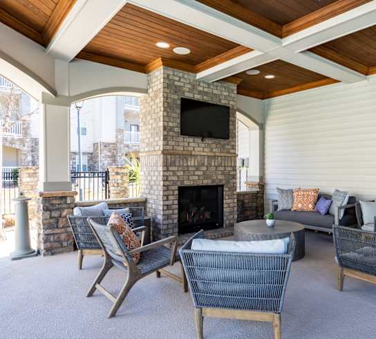 a living room with couches and chairs and a fireplace