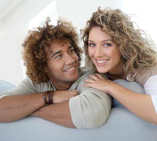a man and a woman laying on a couch
