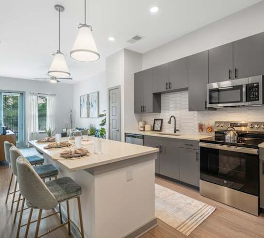 A modern kitchen with a dining table and chairs.