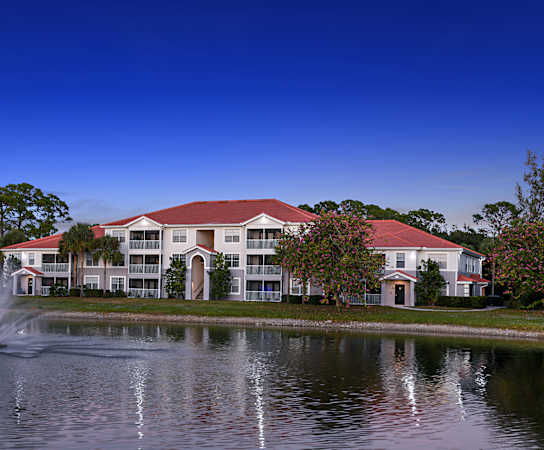 a large pond with a fountain in front of a building at The Ashlar, Florida