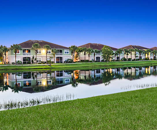 a pond in front of a row of houses at Bay Breeze Villas, Fort Myers, FL, 33908