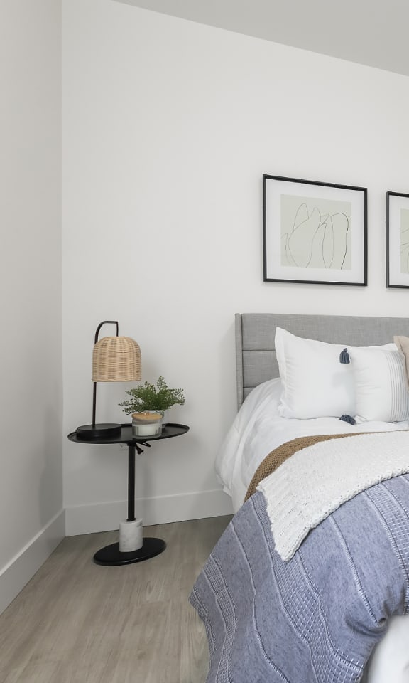 a bedroom with a bed and two pictures on the wall
