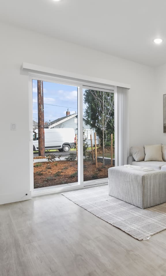 a living room with a couch and a sliding glass door