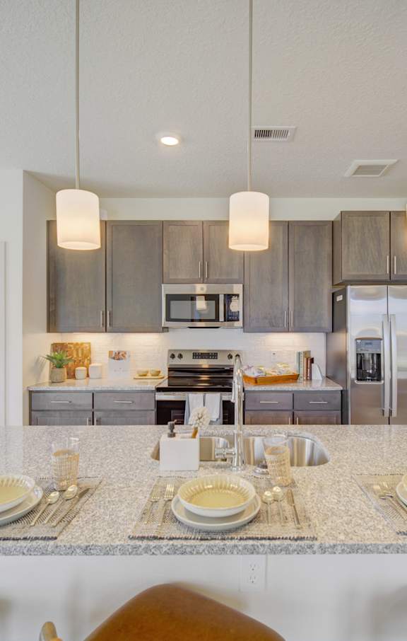 an open living room and kitchen with a ceiling fan at The Enclave at Deer Moss Creek, Florida