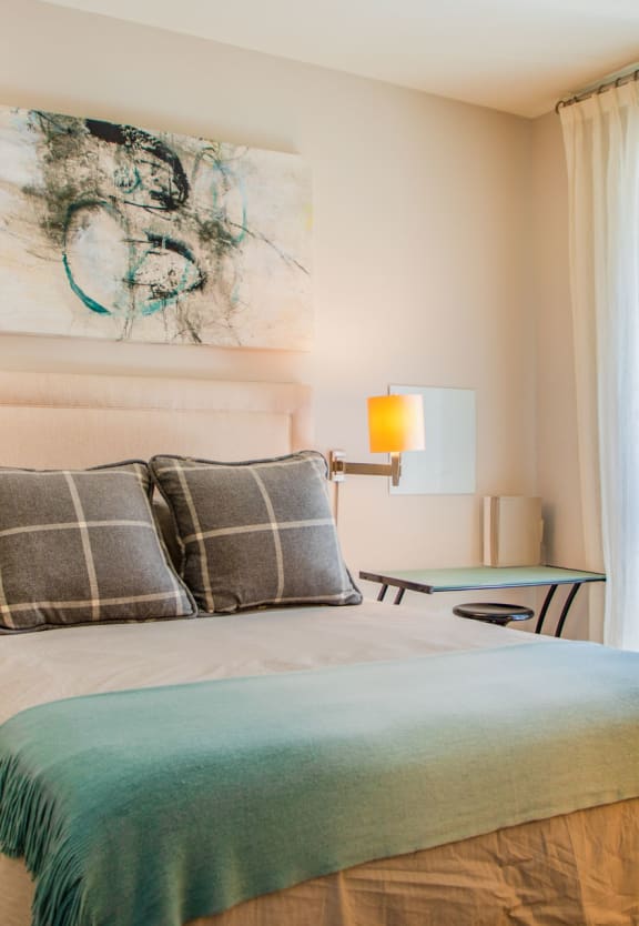a bedroom with a bed and a window at Metro Crossing Apartments, Owings Mills, Maryland