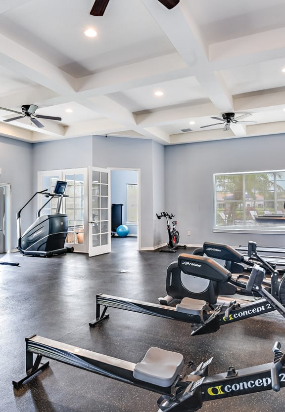 a home gym with exercise equipment and a tv at Cypress Legends, Fort Myers, FL, 33905