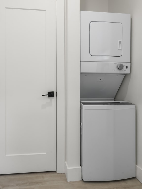 a white room with a refrigerator and a washing machine