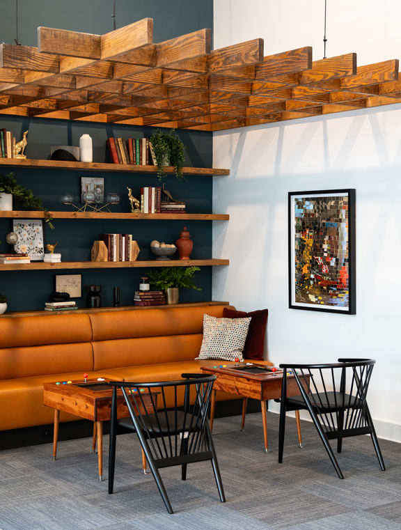 a living room with a brown couch and a table and chairs