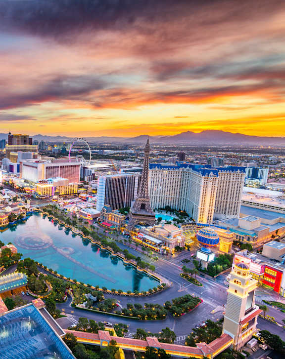 A cityscape with a large building in the center and a fountain in the foreground at 2900 Lux Apartment Homes, Las Vegas, 89102