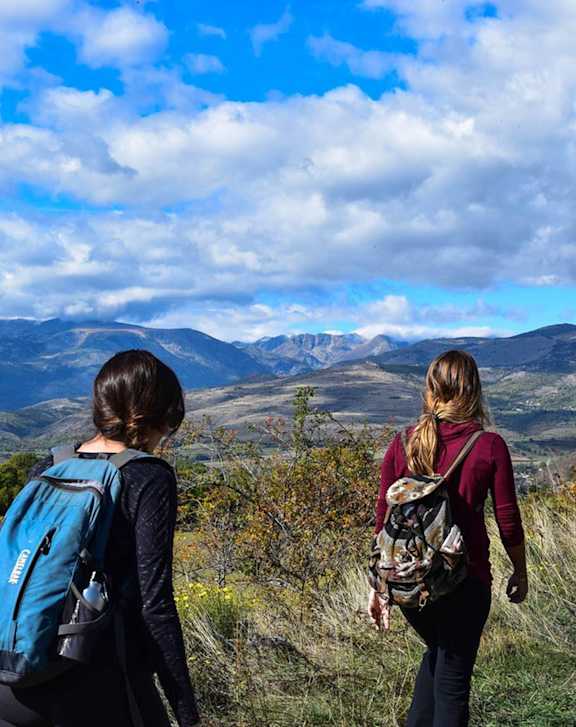 Two people are hiking in a mountainous area at Heritage at Stone Mountain, Northglenn, CO 80233