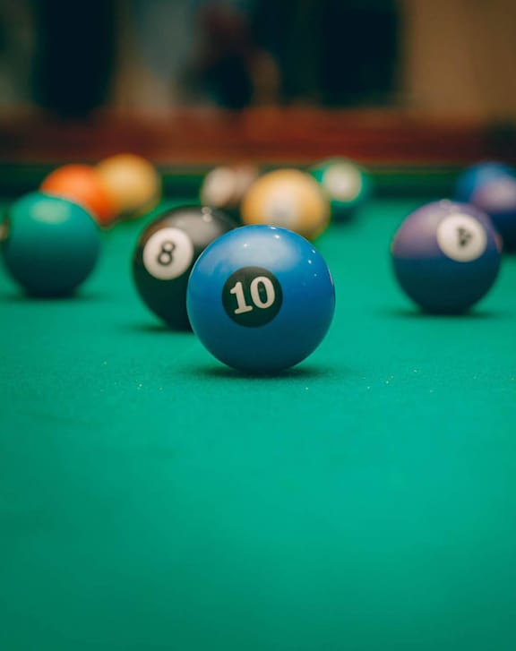 A pool table with a blue ball marked 10 in the foreground at Riverwalk Apartments, Lawrence, Massachusetts 01843