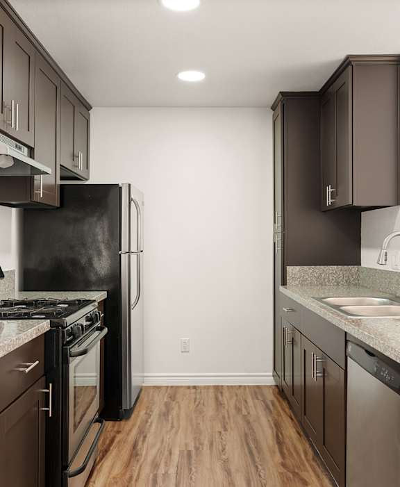 A kitchen with brown cabinets and a black fridge.