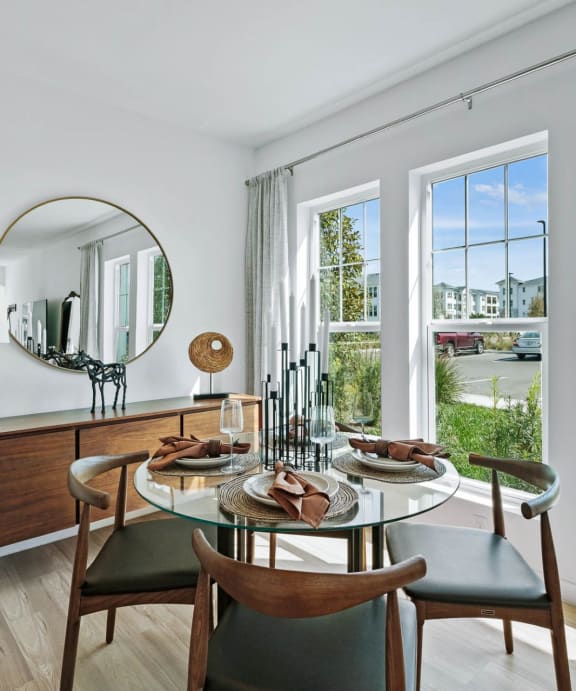 A dining room with a round table and chairs. at Altis Twin Lakes Apartments, Kissimmee, FL 34744