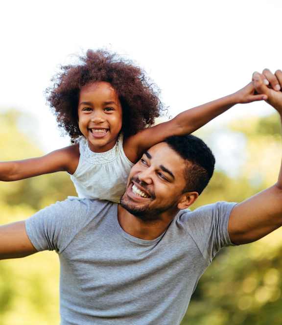 Man Playing with His Daughter at One Rocky Ridge Apartment Homes in Douglasville, GA