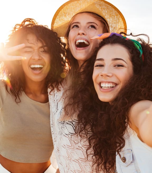 a group of women are laughing on the beach at Esplanade District Apartments, Little Rock