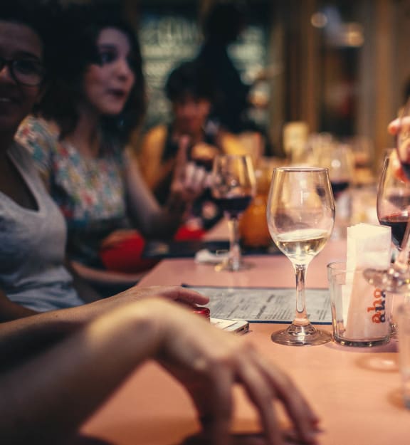 people sitting around a table drinking wine