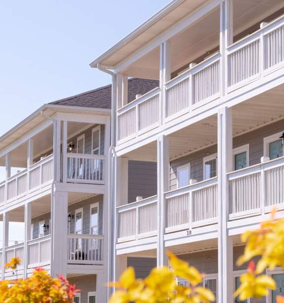 White building with balconies at Club Villas Apartments, Georgia