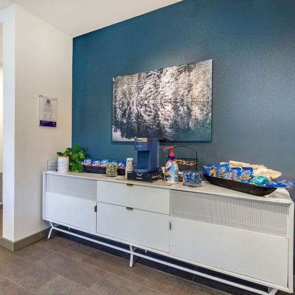 resident coffee station with a blue wall and an elegant white cabinet at 128 on State, Kirkland, 98033