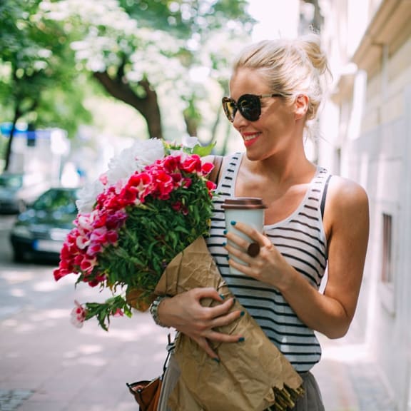 Woman Carrying Flowers on mainstreet in downtown durham
