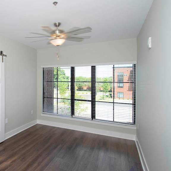 A room with a sliding door and a ceiling fan.