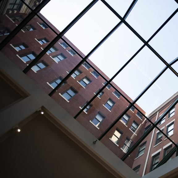 the view of an old brick building through a glass window