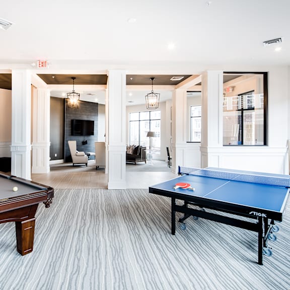 A room with a pool table and a ping pong table.