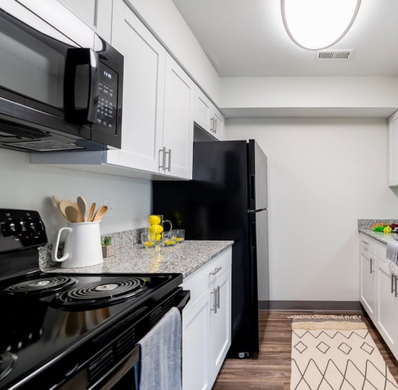 Modern Kitchen with White Cabinetry and Efficient Appliances at Governor Square in Carmel, IN