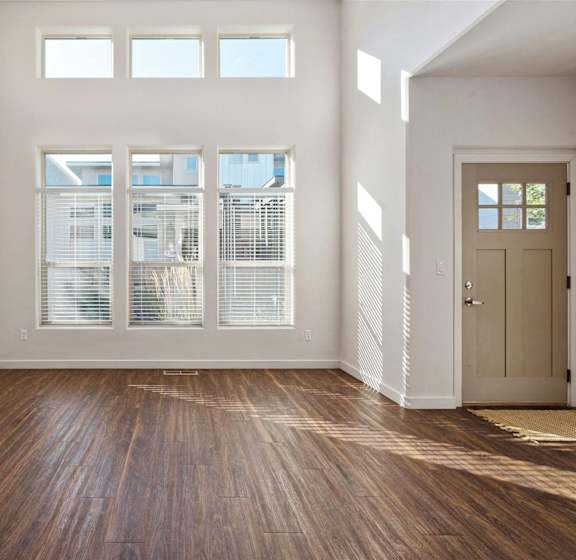 A modern living room with a fireplace and hardwood floors.