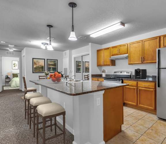 a kitchen with a large island with a breakfast bar