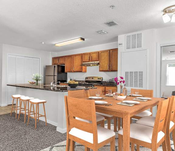 a kitchen and dining area with a wooden table and chairs