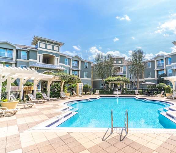 a swimming pool in front of an apartment building