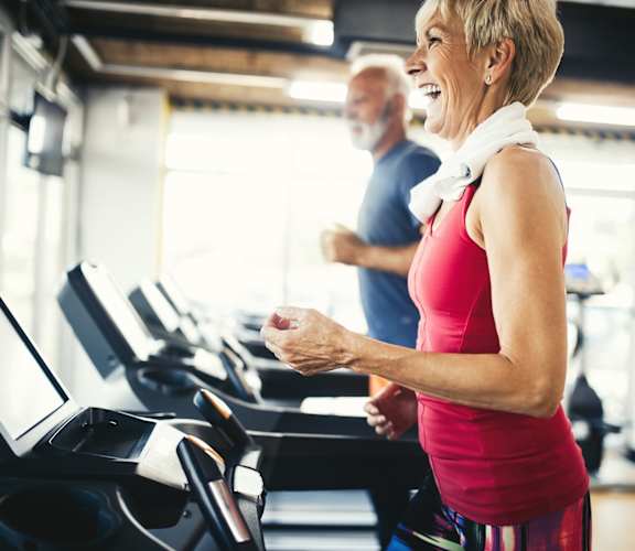 Elderly people on treadmills