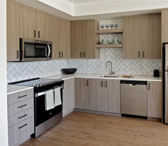 a kitchen with wooden cabinets and stainless steel appliances